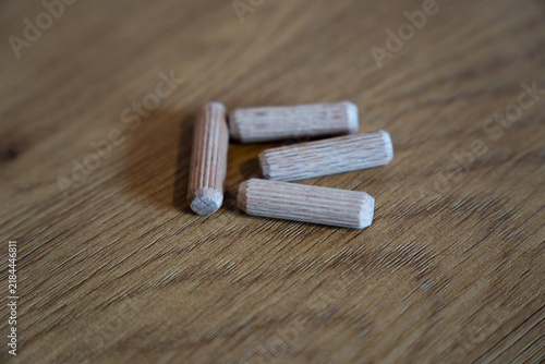 Wooden dowel pins for furniture assembly on wood surface