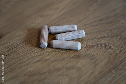 Wooden dowel pins for furniture assembly on wood surface