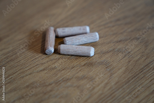 Wooden dowel pins for furniture assembly on wood surface