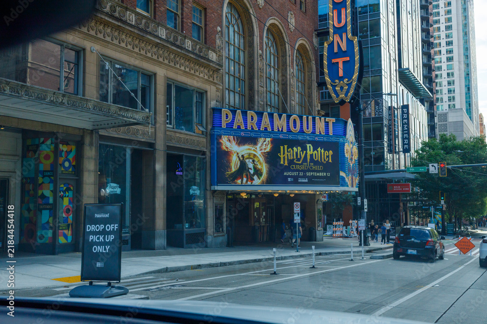 Fototapeta premium The Paramount Theatre marquee advertises Harry Potter and the Cursed Child, running August 22 to September 12, its vertical blade sign glowing above a downtown street.