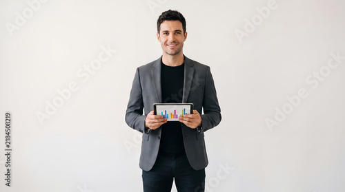 Business Man Tablet displaying financial graphs and data charts, professional, corporate, executive, finance, technology