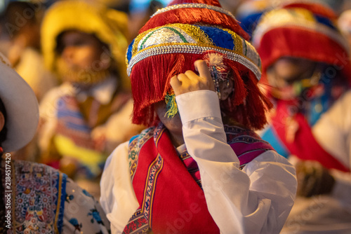 Close Up Details of Dancers in Colorful Traditional Costumes and Masks at a Peruvian Folk Dance Festival Parade