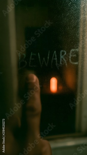 POV Writing Beware in Steam on Bathroom Mirror at Halloween.