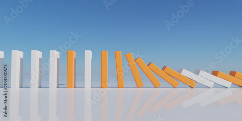Orange and white dominoes falling in a line against a blue sky domino effect toppling chain reaction