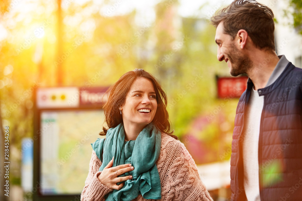 Naklejka premium Happy, couple and walking in city with smile, flare and quality time together with commute. Space, woman and man with connection in urban street, bonding and healthy relationship with trip downtown