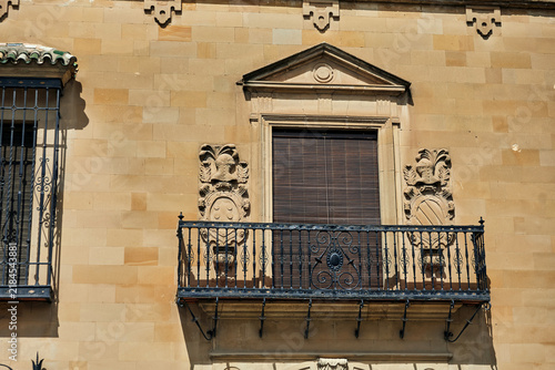 Konstfotografi Ornate wrought iron balcony with carved stone heraldic shields and triangular pe