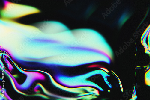 Abstract iridescent liquid background with vibrant holographic rainbow colors flowing over a dark metallic surface.