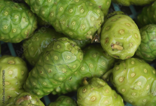 Many fresh noni fruits as background, Morinda citrifolia	