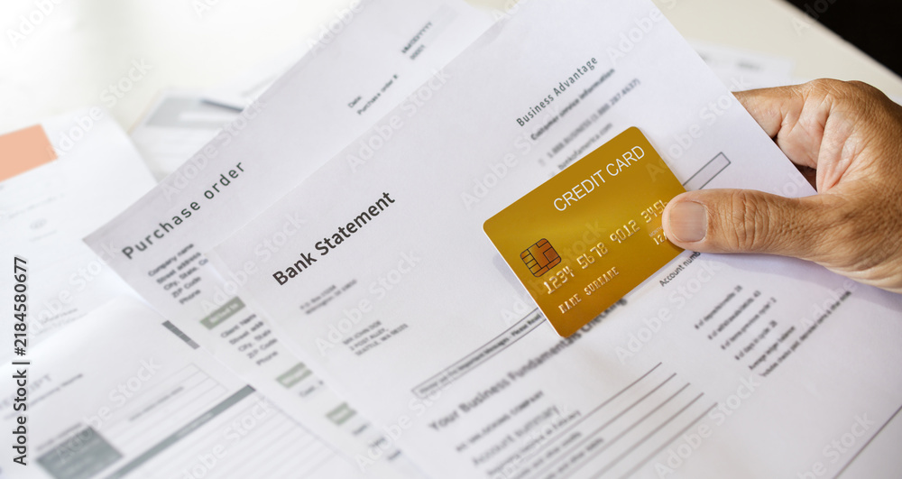 Obraz premium close-up shot, asian man doing online business, E-commerce checking bank statement and order before using credit card to payment