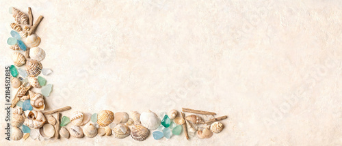 Seashell frame border on neutral background, Coastal beach seashells sea glass flat lay, Summer ocean shells background with copy space, Marine seashell frame layout, Natural beach border background.