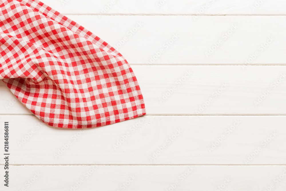 Obraz premium top view with red empty kitchen napkin isolated on table background. Folded cloth for mockup with copy space, Flat lay. Minimal style
