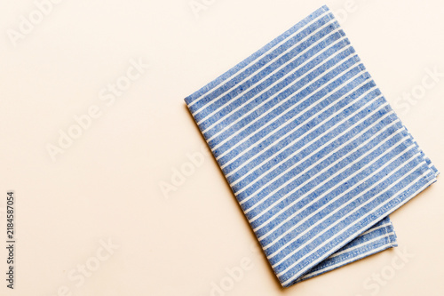 Obraz na płótnie top view with blue kitchen napkin isolated on table background