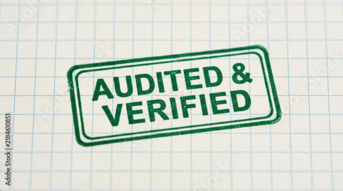 Audited verified stamp on graph paper representing esg reporting standards for compliance and quality assurance in business processes