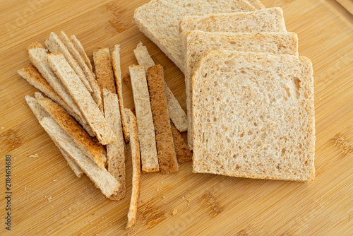 Konstfotografi Cutting the crusts off, crustless bread for sandwiches closeup