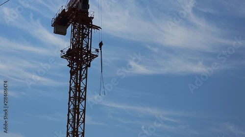 Tower crane working at a modern construction site, showing heavy equipment, building development and engineering processes related to urban growth and infrastructure projects