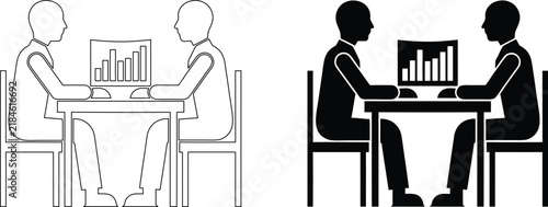 Two business people sitting at a table with a laptop displaying a bar chart indicating financial data.