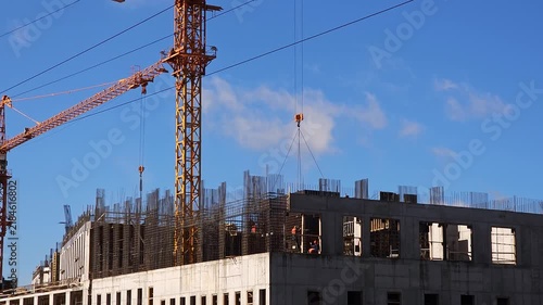 Modern construction site showing high rise building development with tower crane, concrete structure and reinforced steel elements, representing urban growth, engineering and infrastructure projects