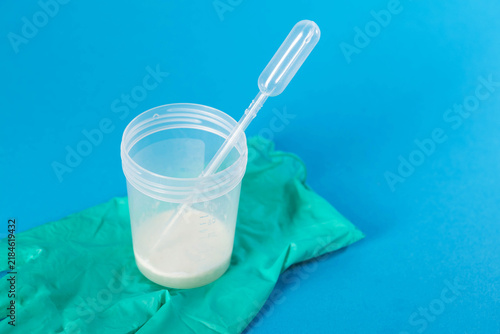 Photography A sperm container on a green medical glove