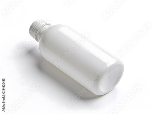 Empty white plastic cosmetic bottle lying down