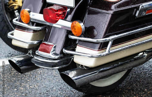 Принти на полотні Rear view of classic cruiser motorcycle with gleaming chrome details, wet burgun