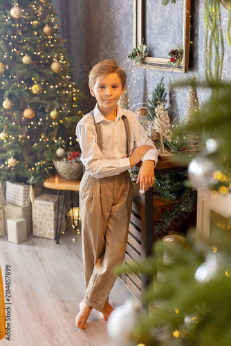 Happy child on Christmas, enjoying some quality time, opening presents, kids on Christmas eve in decorated home