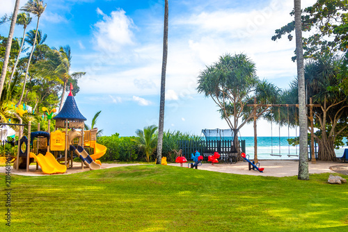 Luxury Marriott Phuket kids playground tropical palms Merlin Beach Thailand.