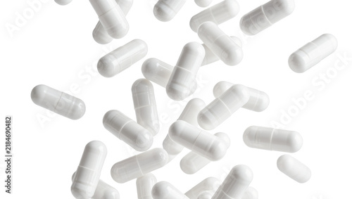 Foto Scattered white pharmaceutical capsules, isolated on transparent background