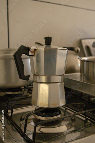 Traditional moka pot on a gas stove in a kitchen