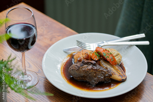 Obraz na plátne Delicious Beef Dish Served With Flavorful Vegetables and a Glass of Red Wine