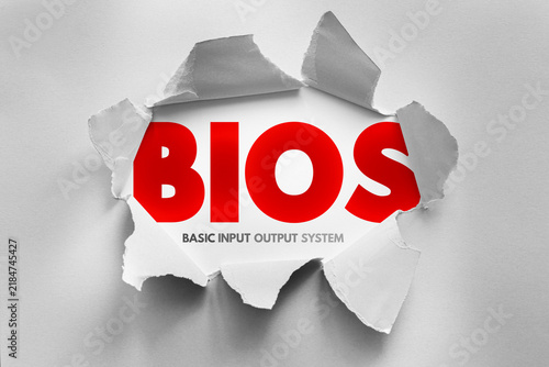 Obraz na płótnie BIOS Basic Input Output System text revealed through torn paper surface, computing technology concept representing firmware control, hardware startup process and system initialization