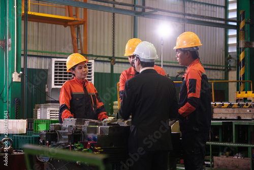 The engineer checks the parts coming out of the machine.