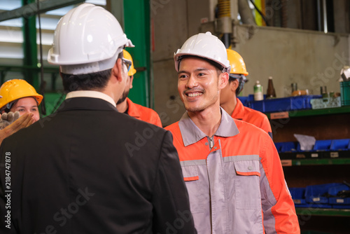 The engineer checks the parts coming out of the machine.