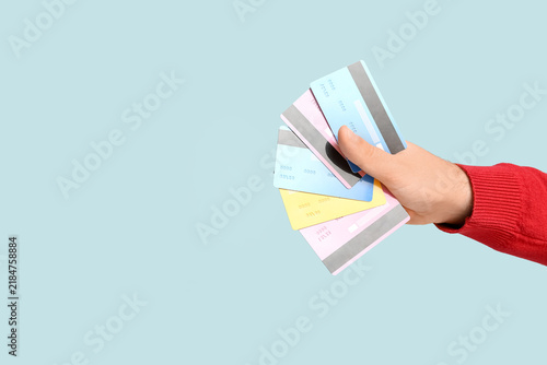 Male hand with credit cards on blue background