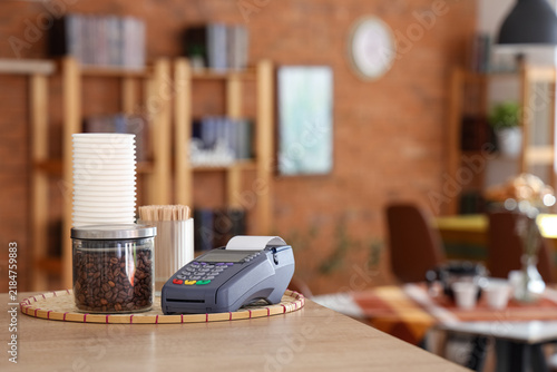 Payment terminal on table in coffee shop, closeup