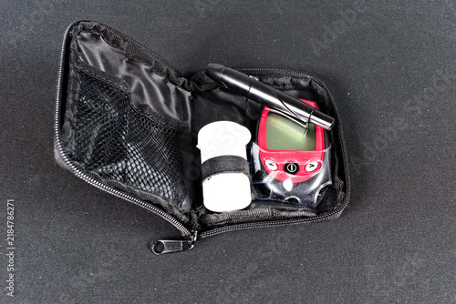 Cuadro en lienzo A compact diabetes testing kit containing a glucose meter, lancet device, and test strips is neatly organized within its portable black case