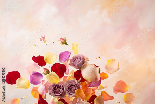 Colorful rose petals and flowers floating in dynamic explosion on pastel background