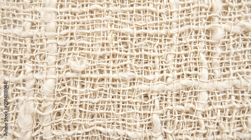 Close up of intricate handwoven natural fiber textile showcasing varied knotting and looping patterns
