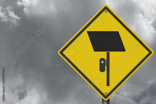 Surveillance camera icon yellow warning sign with stormy sky for license plate reader LPR