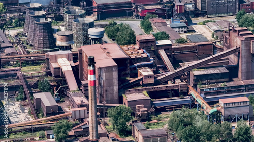 Aerial view of the Dolni Vitkovice industrial complex featuring massive cooling towers, metal piping, and historic steel structures in Ostrava, Moravian-Silesian Reg, Czechia.