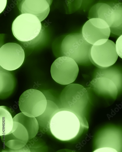 Abstract green light bokeh background, soft glowing circles for holiday design