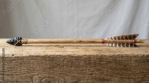 Authentic Primitive Arrow With Flint Head And Feather Fletching On Rustic Wood