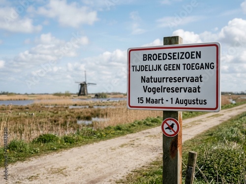Bird Reserve Signage Warns Against Entry During Breeding Season With Windmill Backdrop