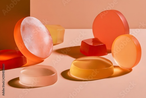 Translucent gummy shapes on peach studio surface