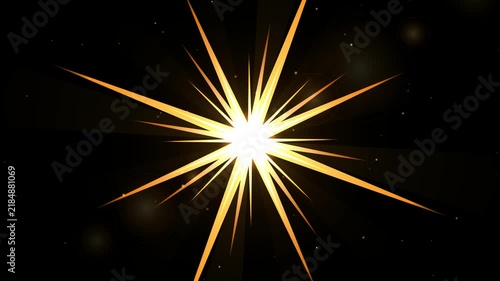 Golden starburst explosion with glowing light rays and particles on a black background 4k video