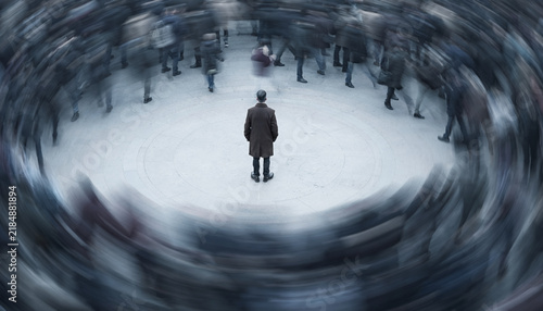 Lone Man Standing Still in the Middle of a Rushing Blurred Crowd