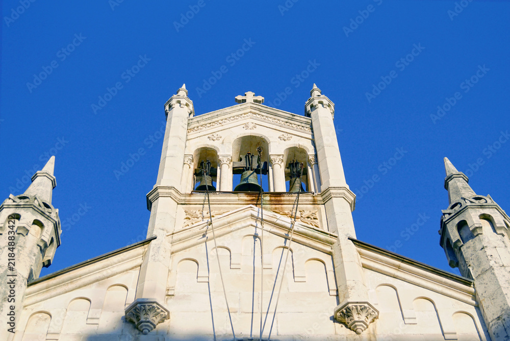 Fototapeta premium Stone belfry of Saint Michael Archangel church with ornate pinnacles on Belavista square, Herceg Novi. Captures architectural eclecticism, Byzantine influences, and multicultural heritage synthesis.