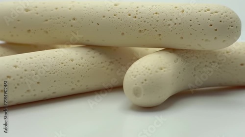 Close-up Macro Shot of Savory Biscuit Sticks on a White Background.