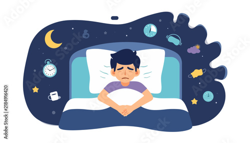 Sleepless man sitting up in bed suffering from severe insomnia.