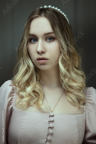Young Woman in Pink Dress Sitting on Blue Armchair