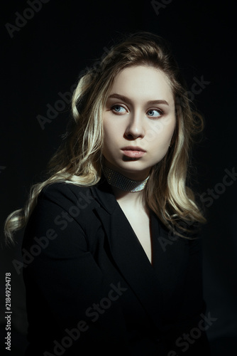 Young Woman Looking Away in Dark Studio Portrait